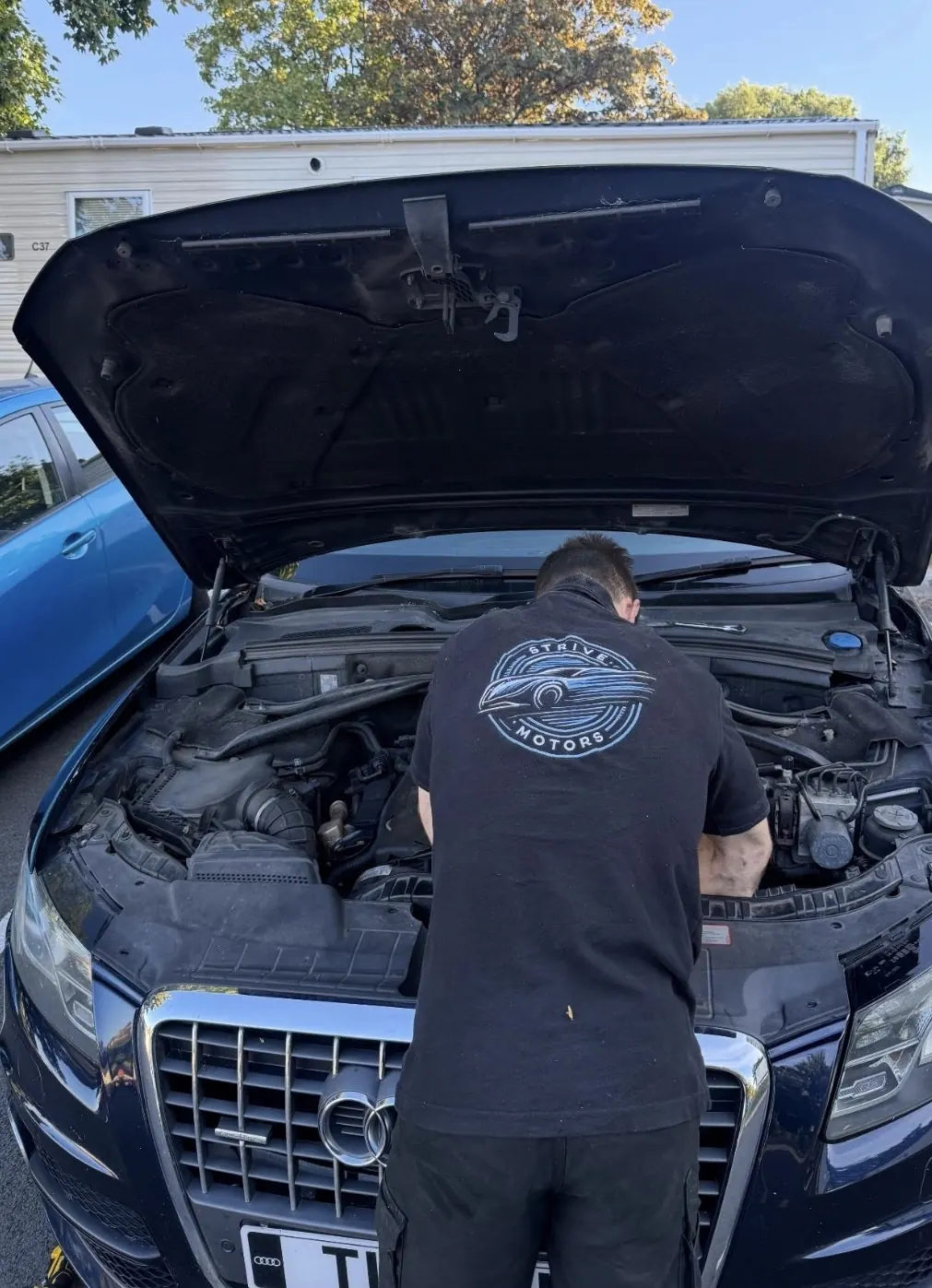 Strive Motors technician diagnosing a vehicle