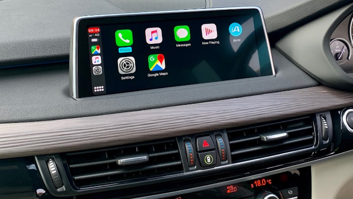Modern Apple CarPlay screen retrofitted into a factory dashboard